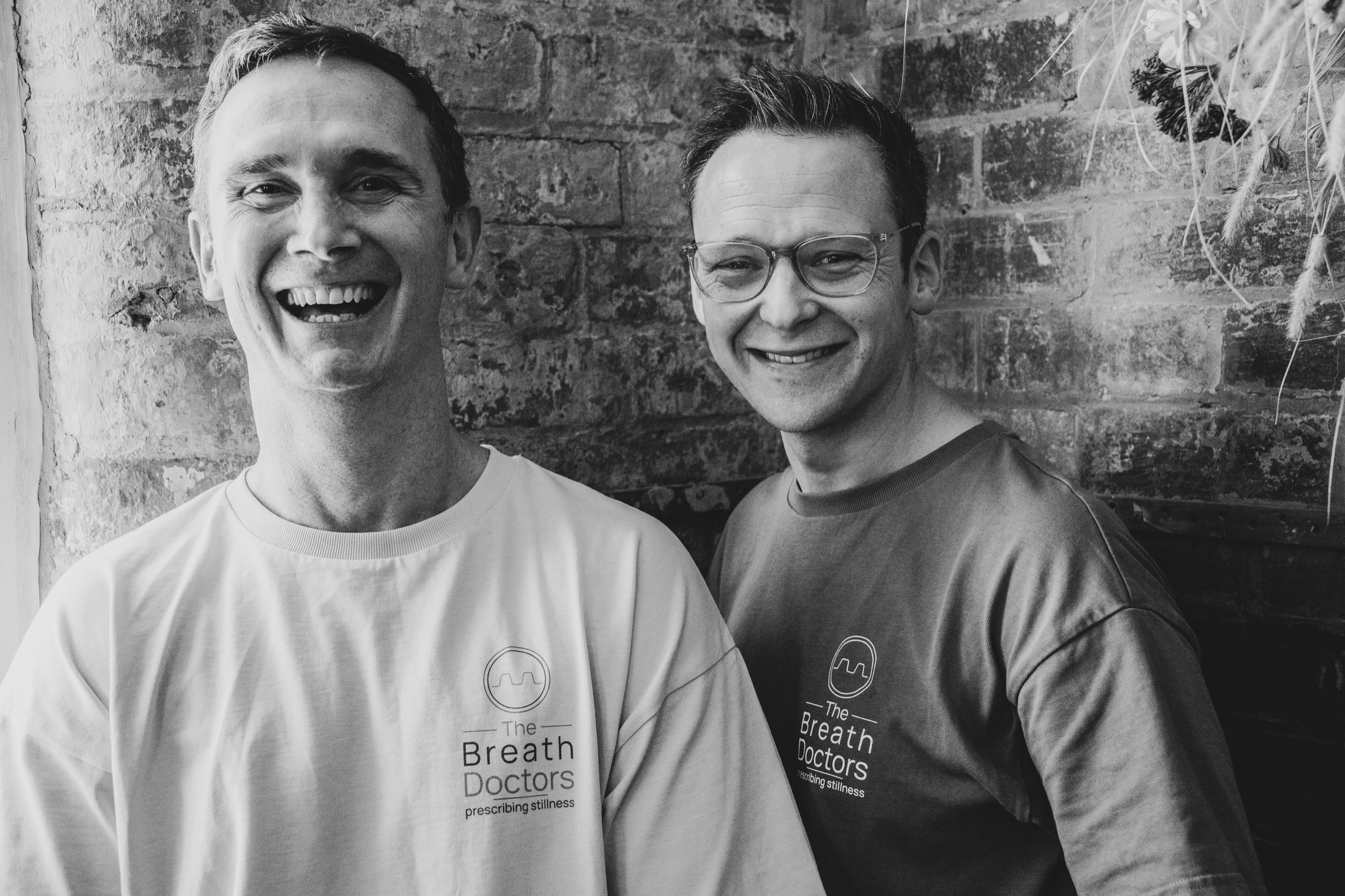 Dr Tim Hughes and Dr James Brunning smiling together, founders of The Breath Doctors