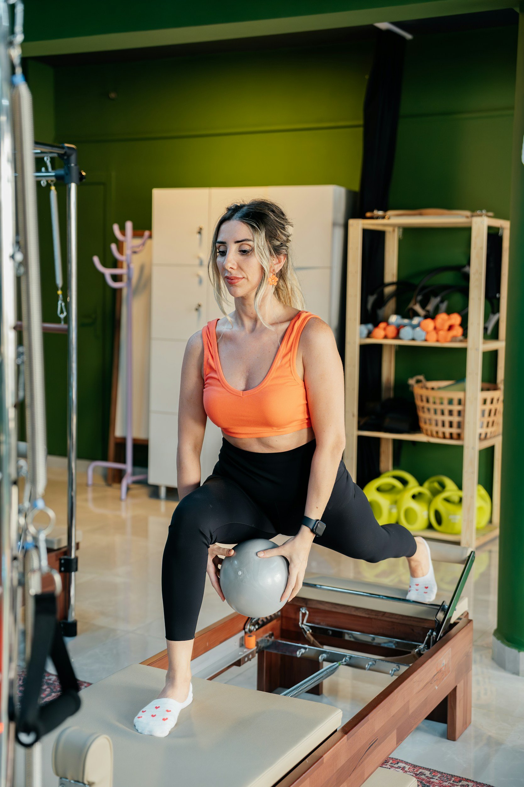 Woman using Pilates equipment during a personalised session
