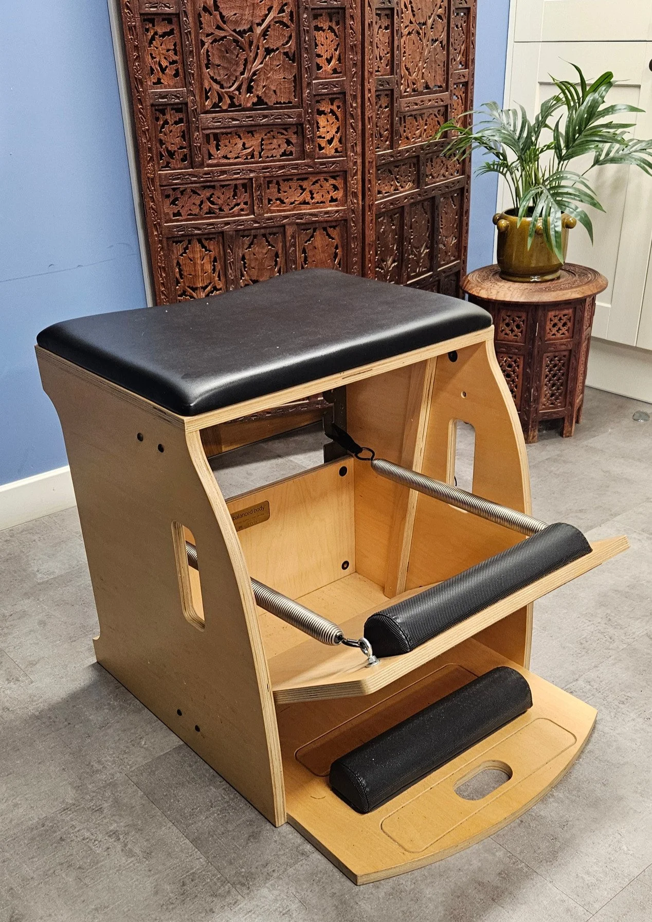 Pilates Wunda Chair with a padded seat and spring loaded pedal in Jenny’s studio