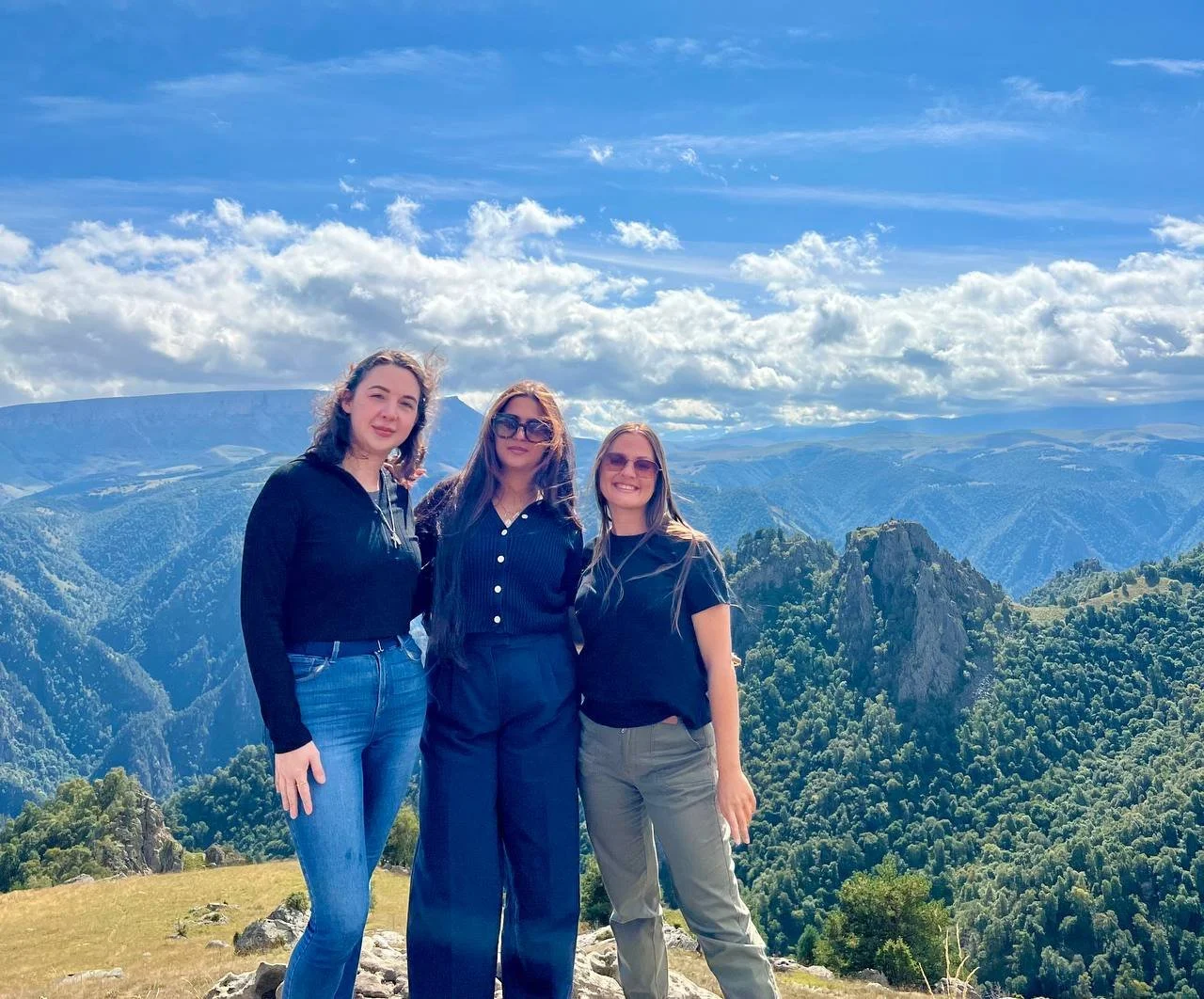 Group trip travellers in the Caucasus mountains, Russia"