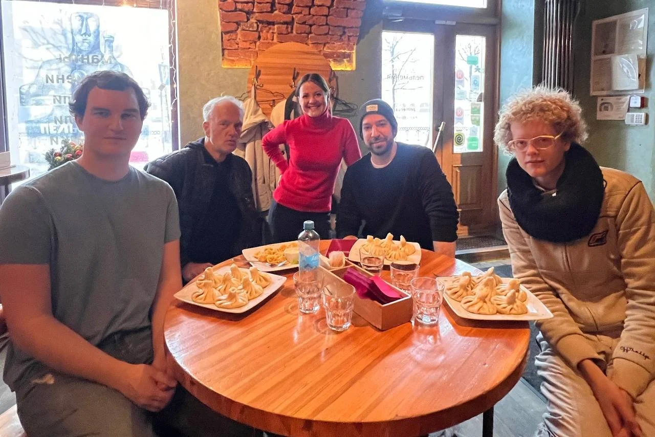 Small group of Western travelers eating pelmeni at a local restaurant in Saint Petersburg, Russia