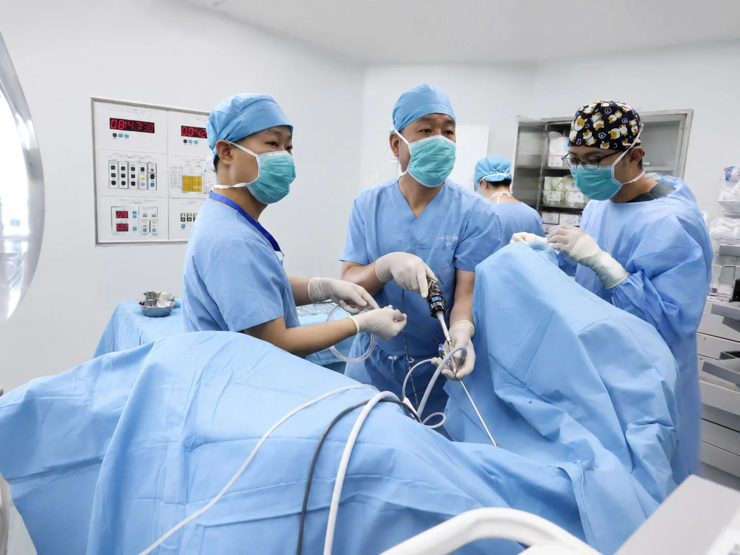 Dr. Zhang in urological operation in operation room with his resident physician