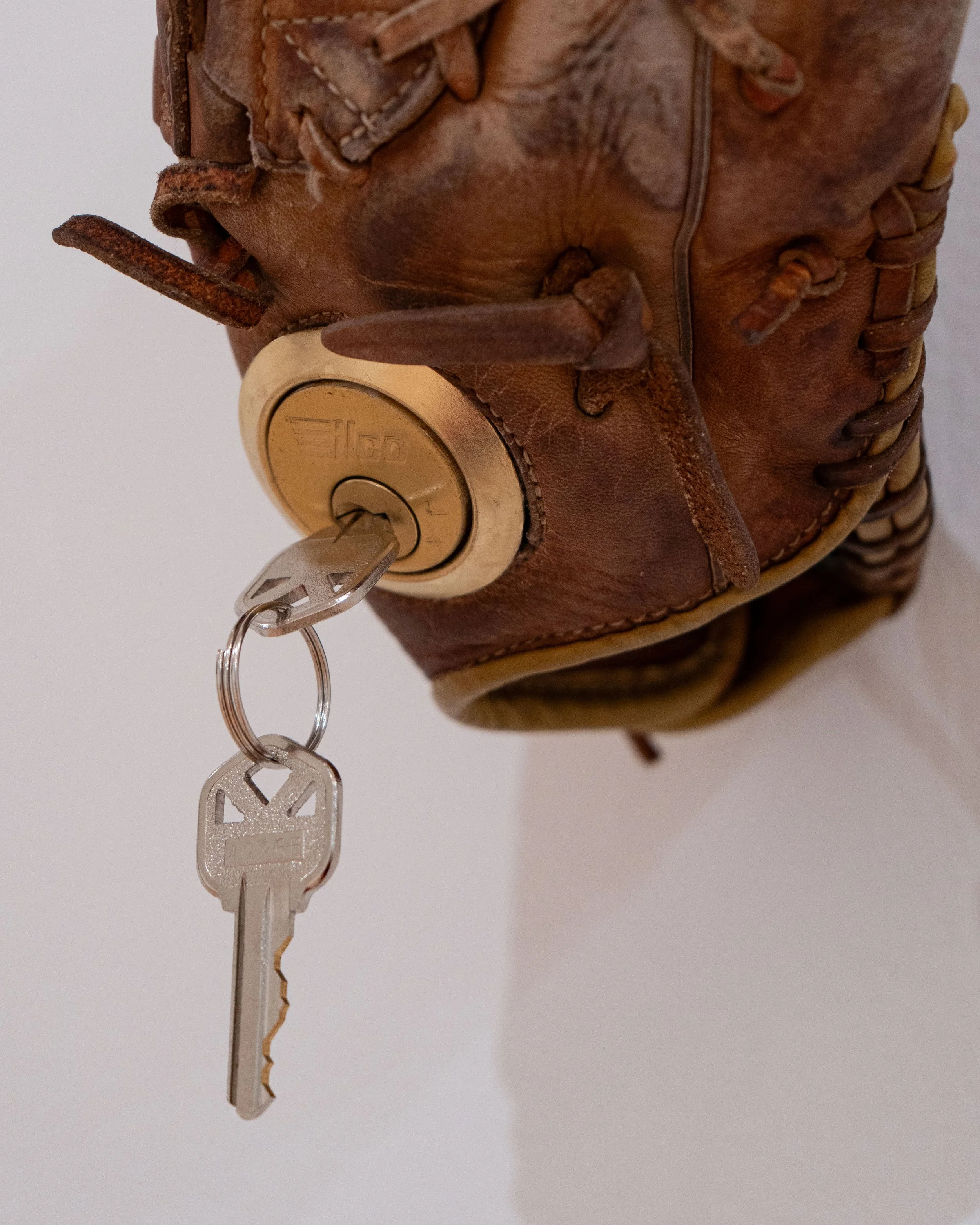   Untitled (Catfish Hunter) —   Leather, partial deadbolt lock, pine rosin
 
Image courtesy of Priya Vaswani