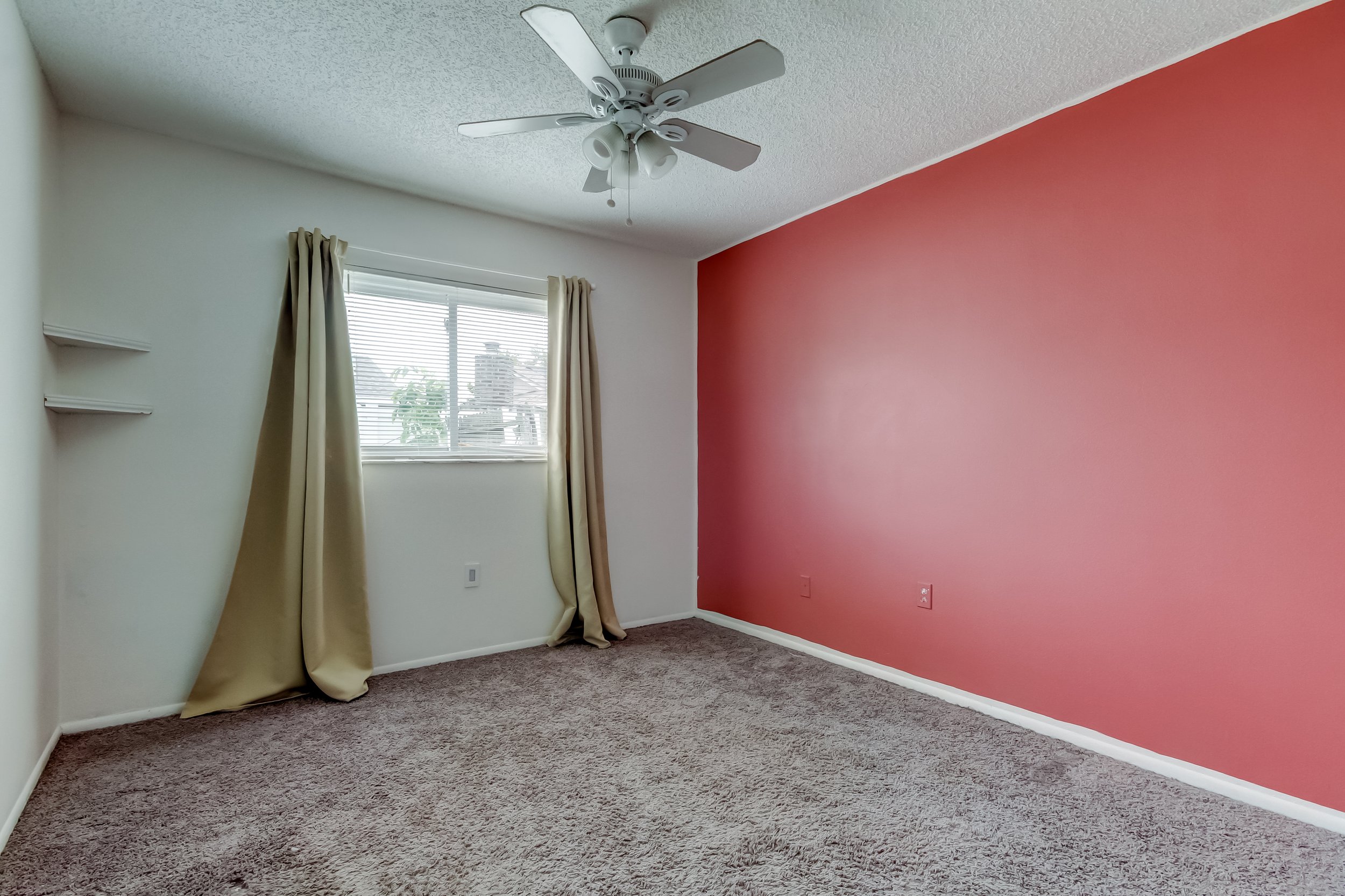 financially distressed bedroom with extreme red wall color empty
