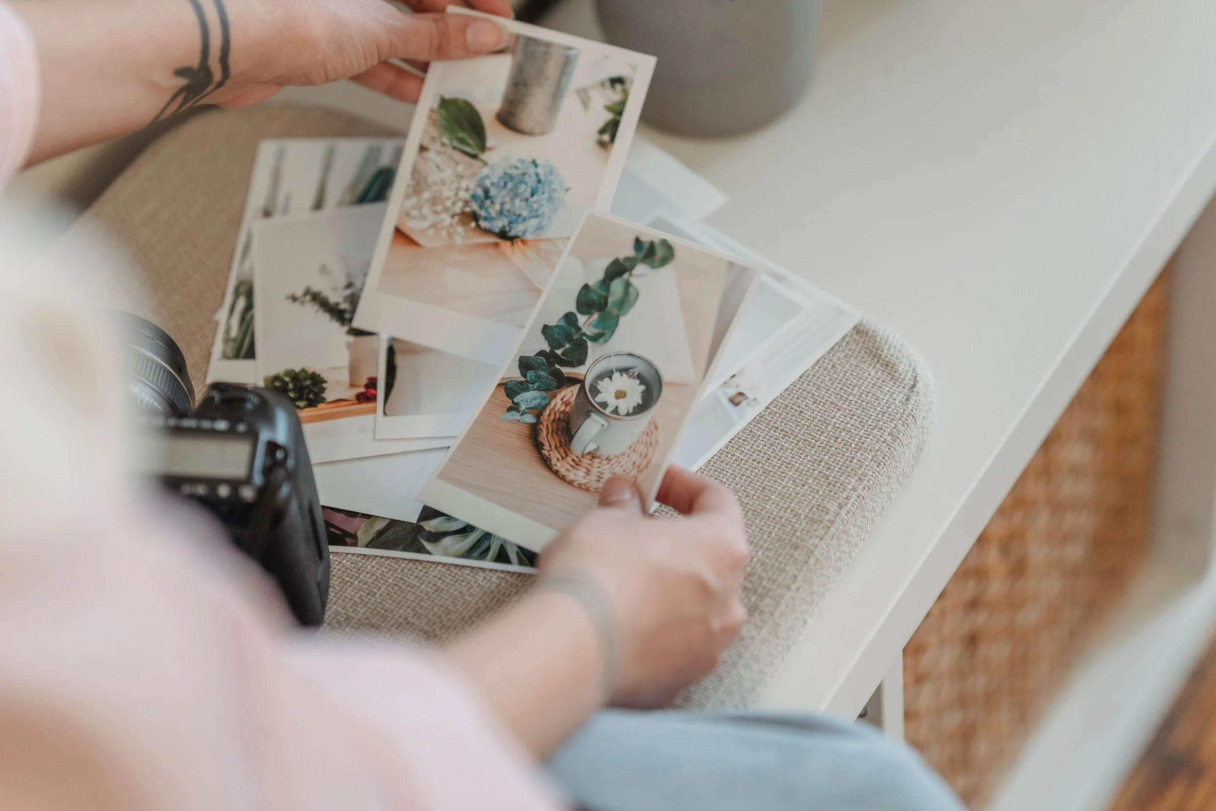 Someone looking through a collection of printed photographs and memories