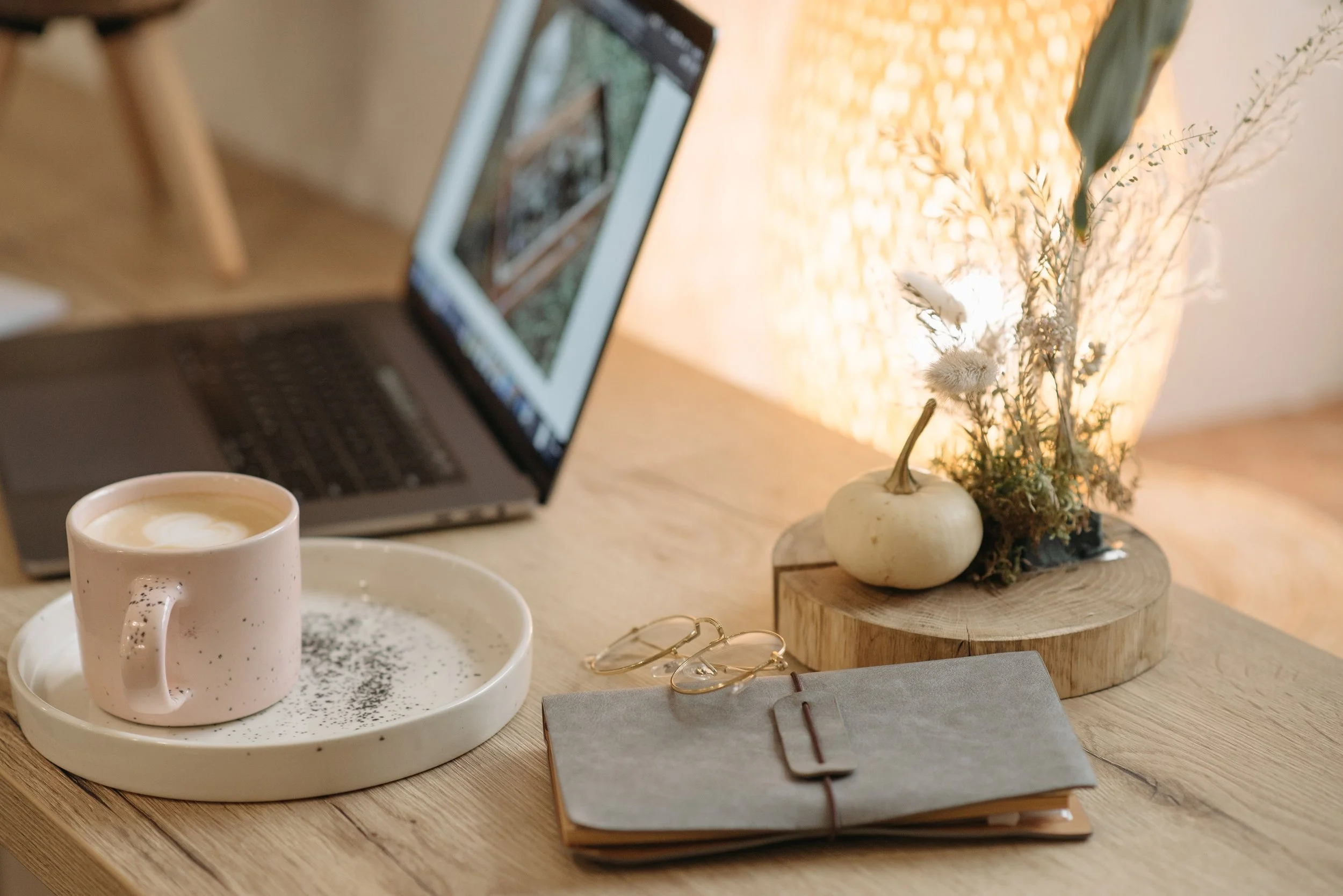 Laptop, notebook and cup set up for a virtual organising and coaching session