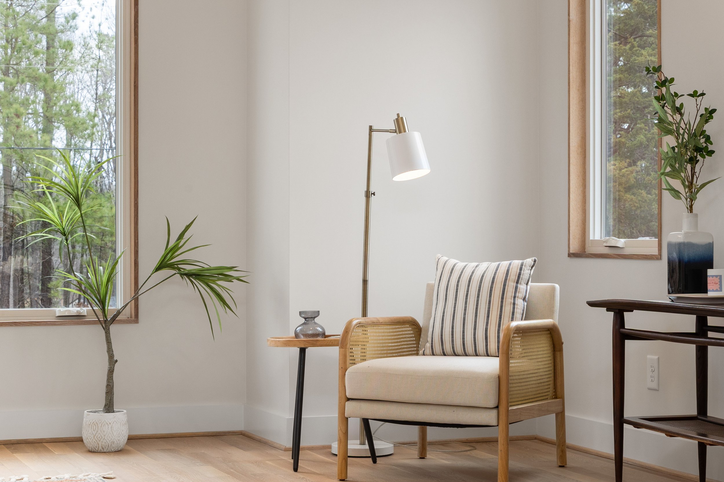 Quiet, uncluttered living space with an armchair and plants