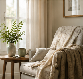 Comfortable armchair with a soft blanket beside a window