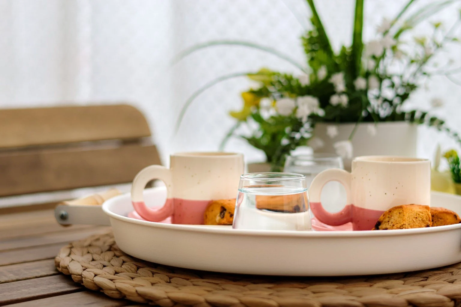 Two mugs and biscuits on a tray, creating a relaxed setting for a conversation