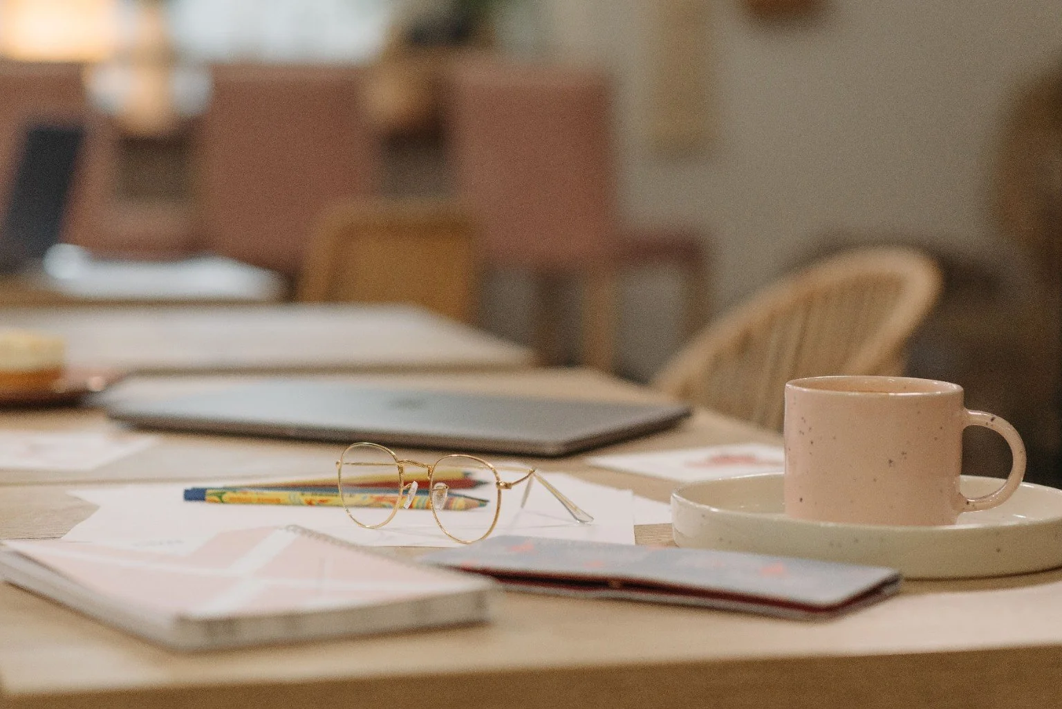 Relaxed workspace with a mug, glasses and papers on the table