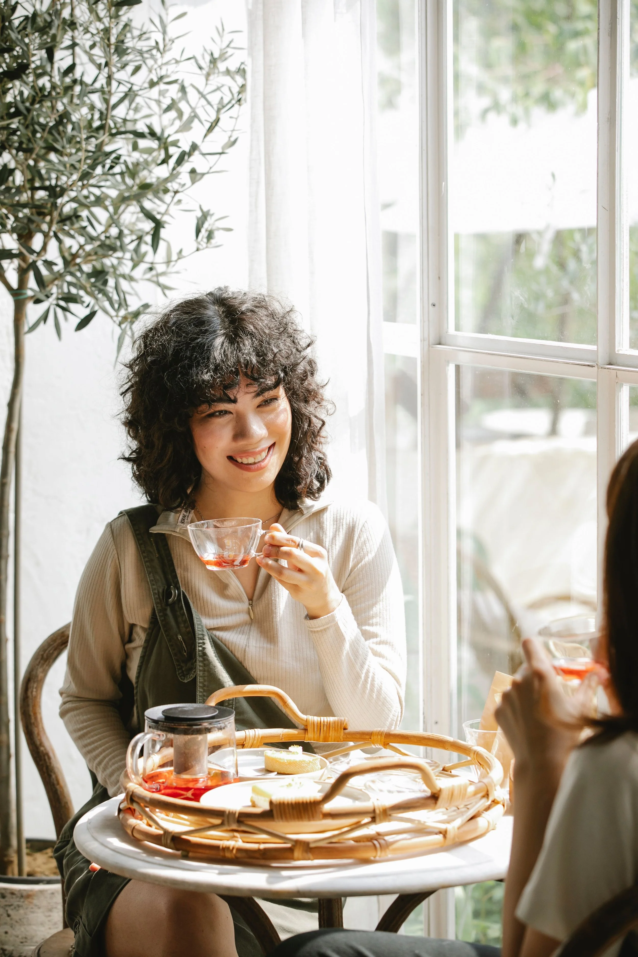 Two people having a relaxed conversation together over tea