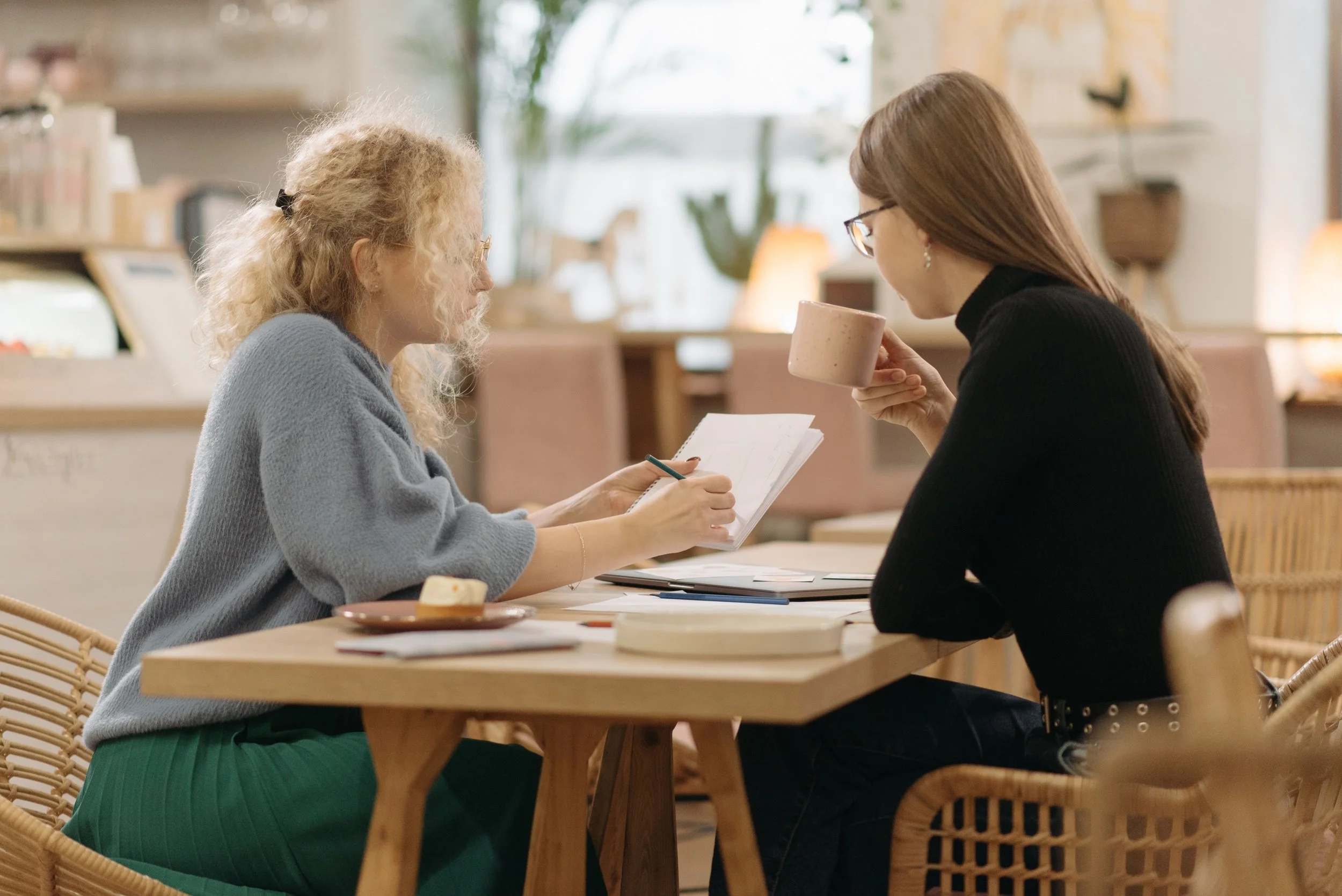 Two women having a relaxed conversation together over a cup of tea
