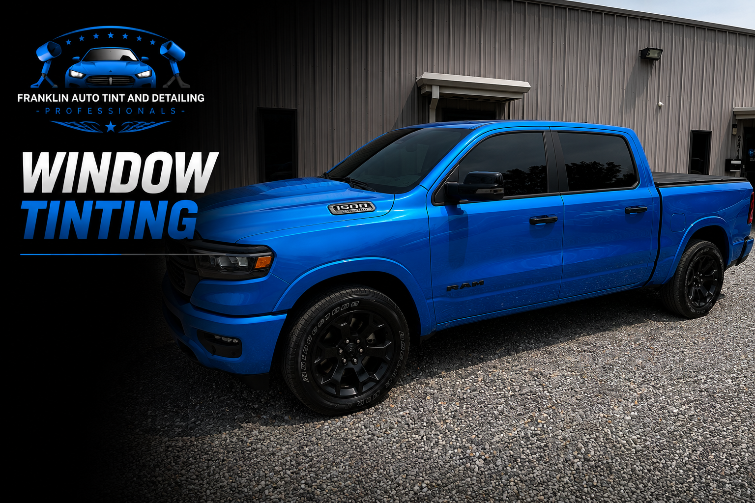 Blue RAM 1500 truck parked outside a commercial building with a gray metal exterior, with a logo for Franklin Auto Tint and Detailing featuring a blue car and two tire-changing tools.
