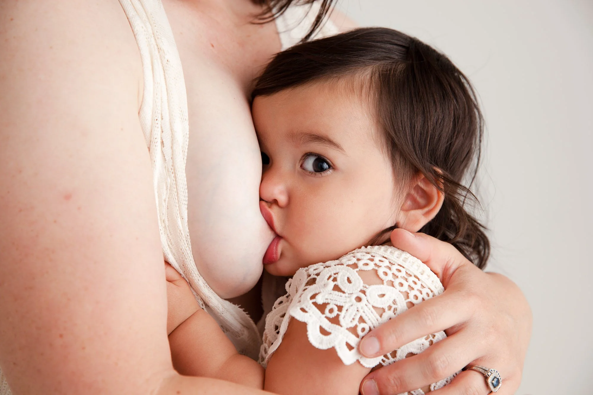 A baby breastfeeding from its mother.