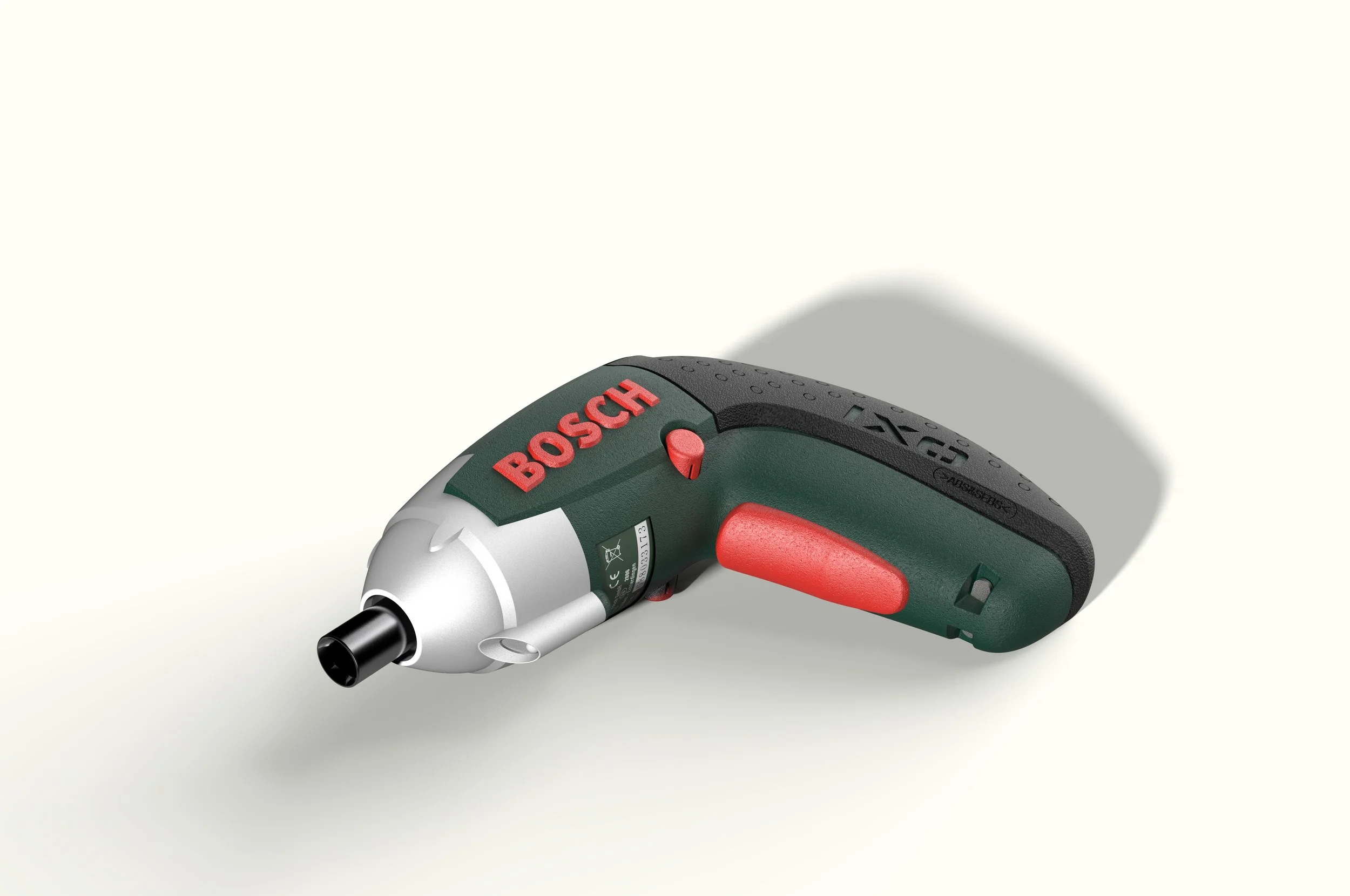 A Bosch cordless electric screwdriver with a black and green body and red accents, lying on a plain white surface.
