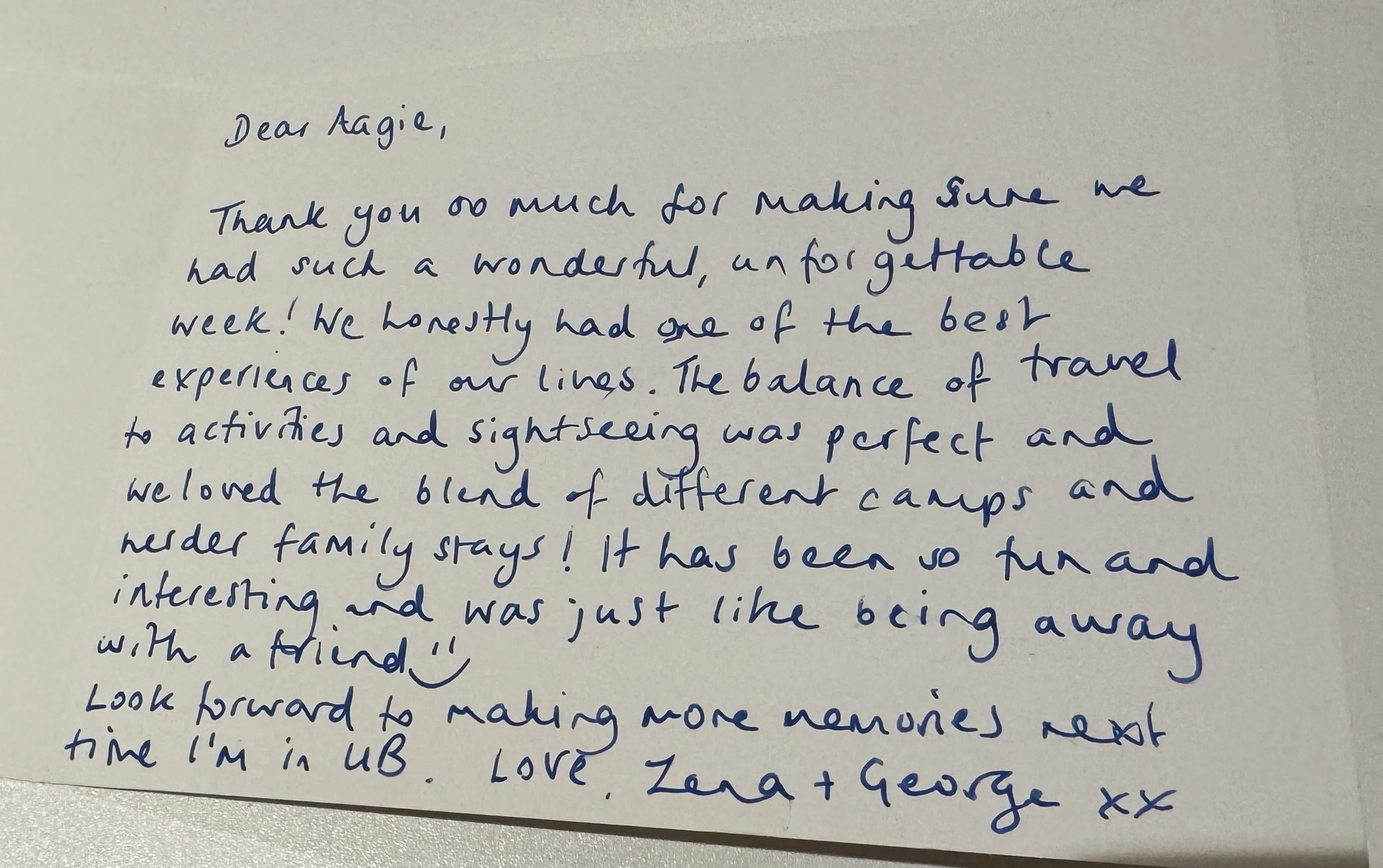 A handwritten letter on a white sheet of paper, written in blue ink, beginning with "Dear Agie" and expressing gratitude and sharing experiences.
