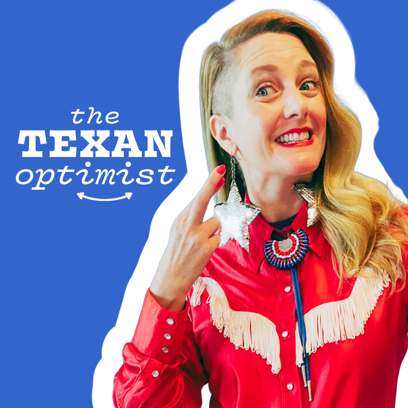 A woman with long blonde hair, dressed in a red Western-style shirt with fringe and pearl snap buttons, is smiling and crossing her fingers. She is wearing large star-shaped sequin earrings and a red, white and blue bolo tie, against a blue backgroun