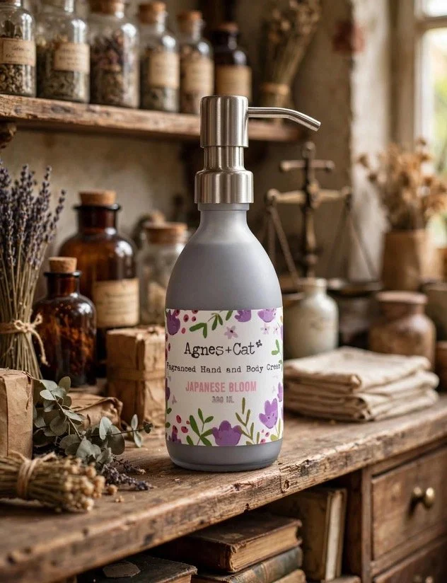Agnes + Cat Japanese Bloom hand and body cream pump bottle on a rustic shelf