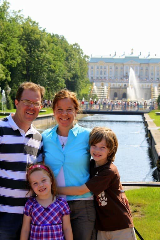 The Sullivan family outside Peterhof Palace in Russia, standing near a fountain on a sunny day.