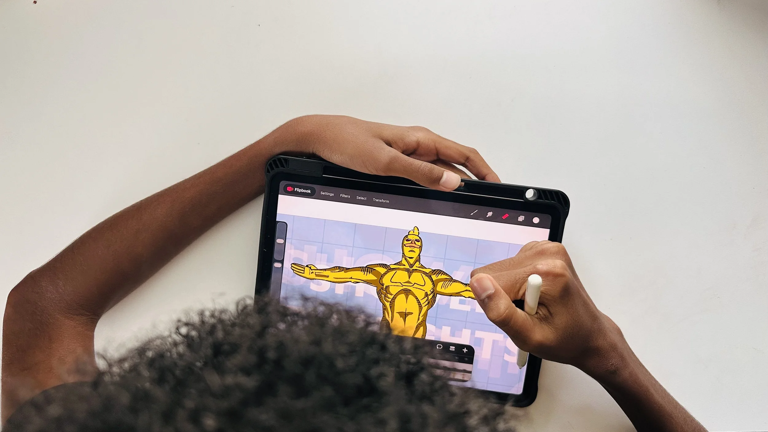 Person holding a tablet with a cartoon superhero character on the screen, on a white background.