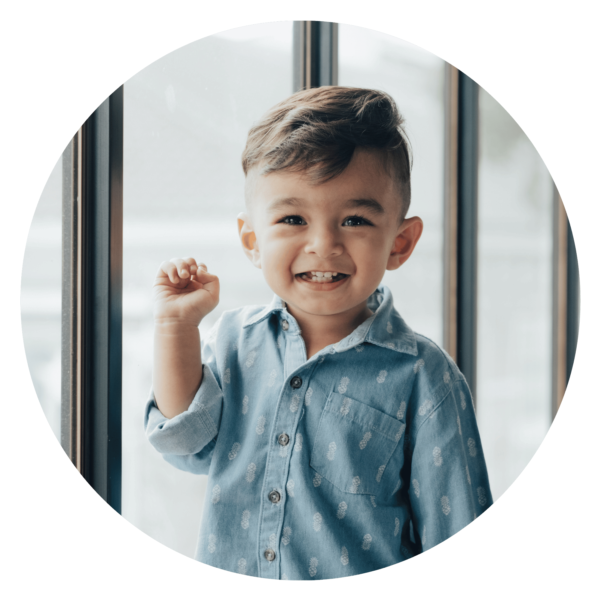 Young child smiling during speech therapy.