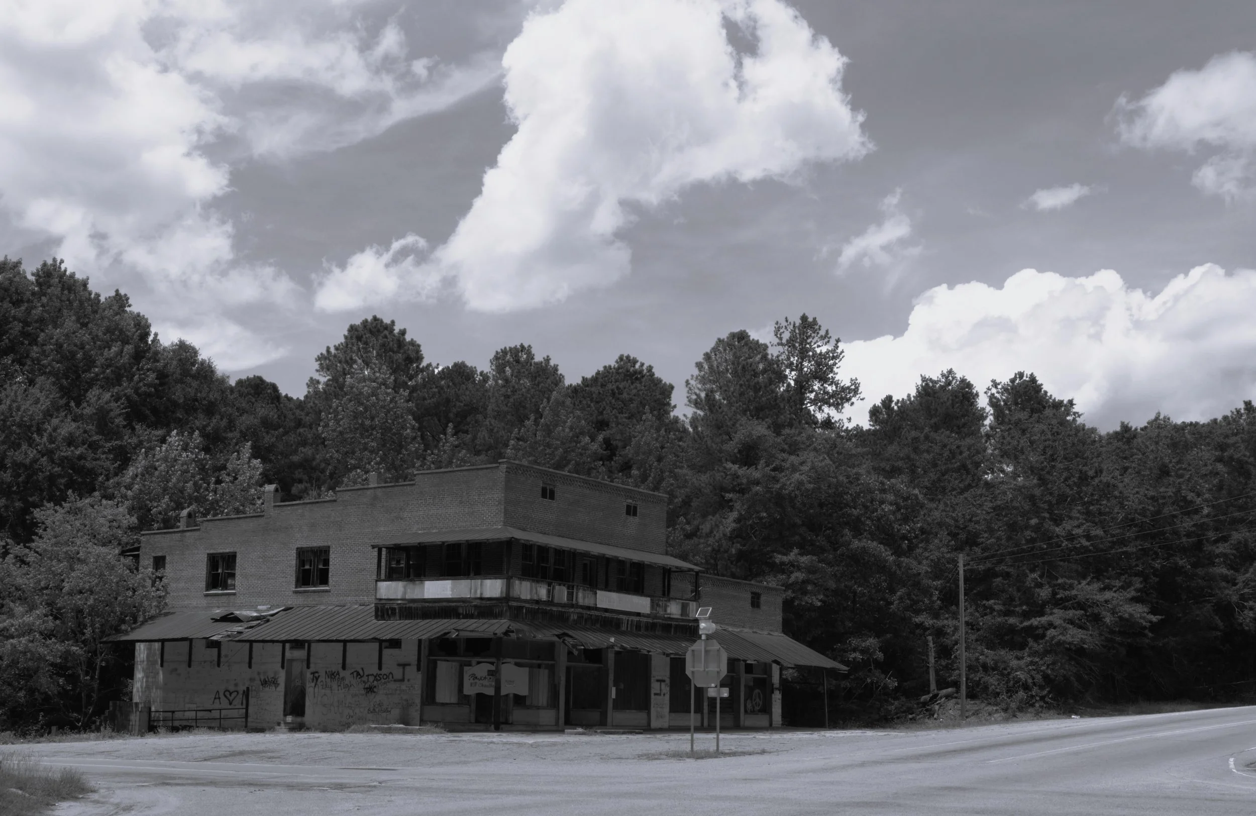 (B&W) Weathered by time, Poole’s Mill along U.S. 178 stands as a reminder of the small communities, local businesses, and roadside landmarks that helped shape South Carolina’s past. Its aging brick walls and rustic storefront preserve a glimpse of an