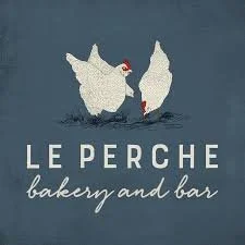 Logo of le Perche bakery and bar featuring two swans on a dark blue background.