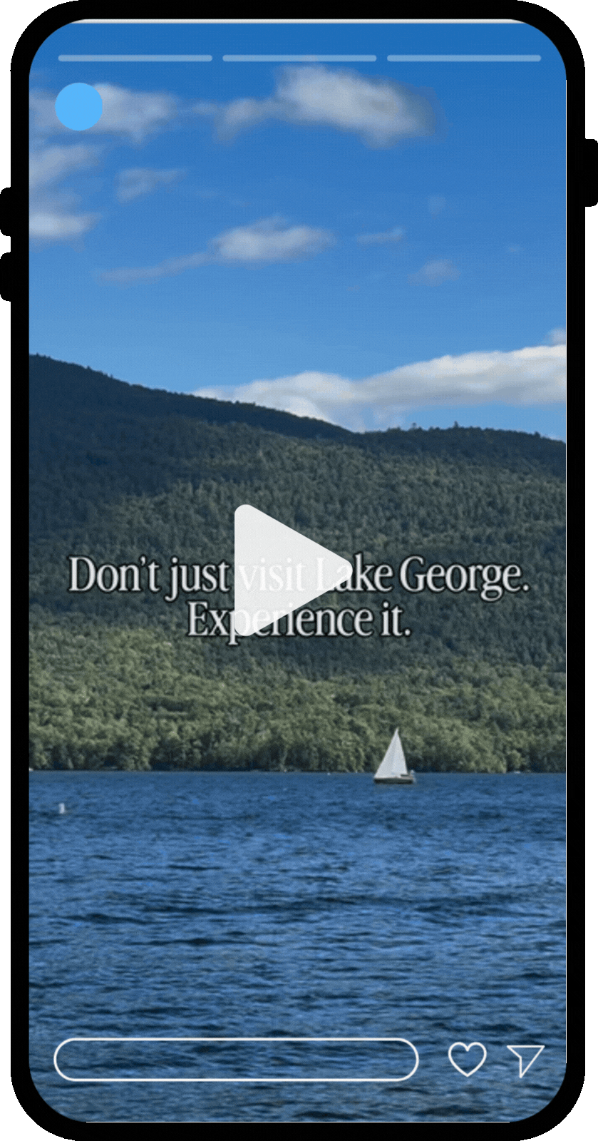 Phone mockup featuring an Instagram reel of Lake George NY, showing the lake with a white sailboat with mountains and blue sky behind it