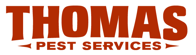 Sign for Thomas Pest Services with large brown text on a black background