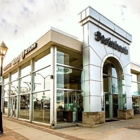 Exterior of Steindbach dealership building showing Jeep, Chrysler, Dodge, RAM, and Stellantis logos.