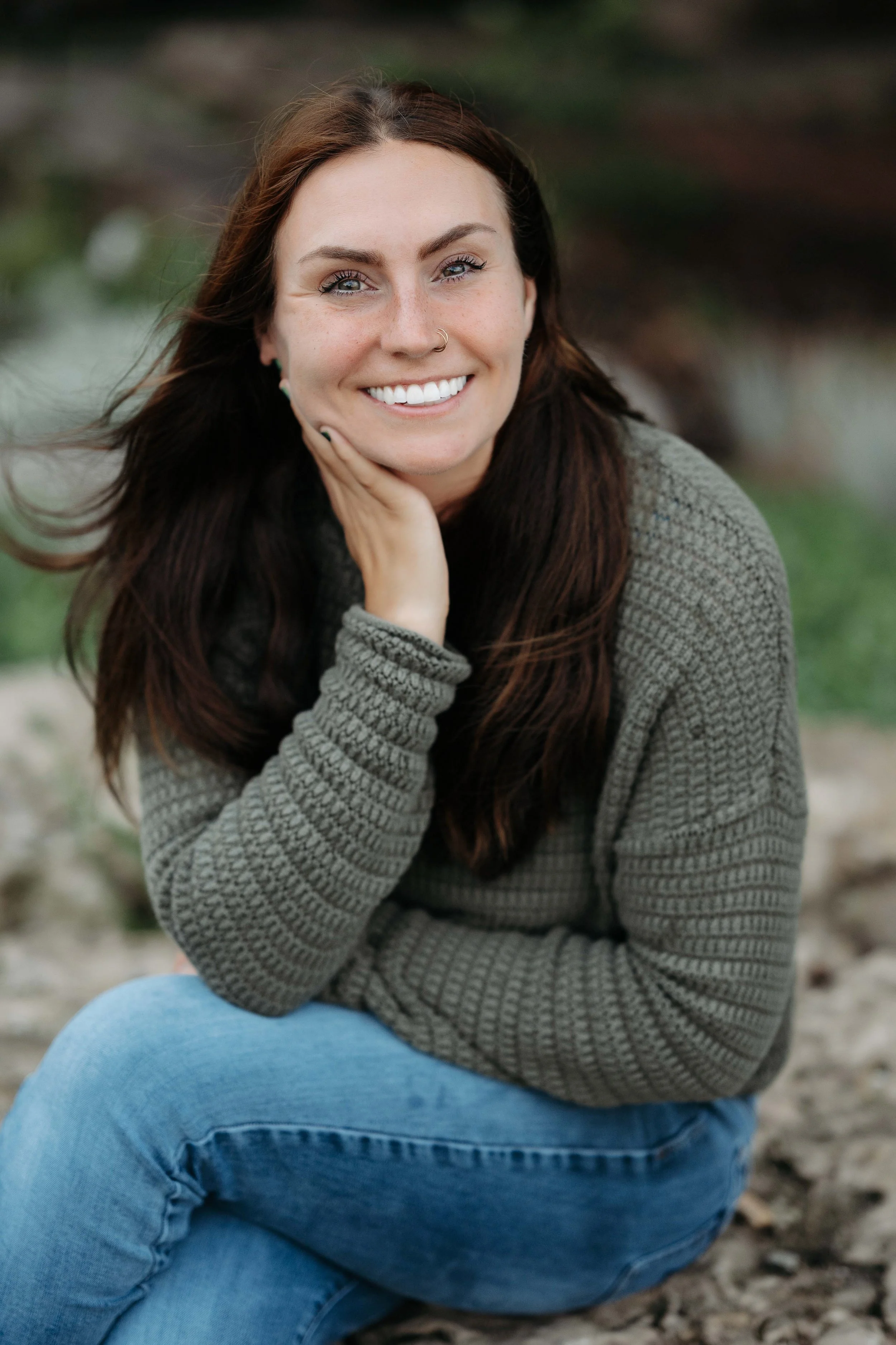 woman smiling close up with hair blowing in the wind