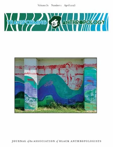 Cover of a journal titled 'Transforming Anthropology' featuring a painting of a woman and ocean waves on a mural.