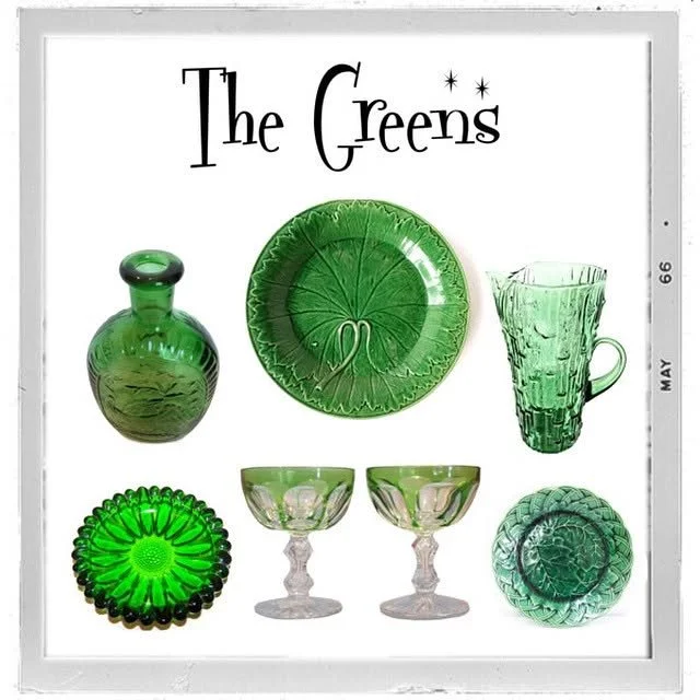 Set of green glassware including a vase, a plate, a mug, a bowl, two goblets, and a small dish, with the words "The Greens" above.
