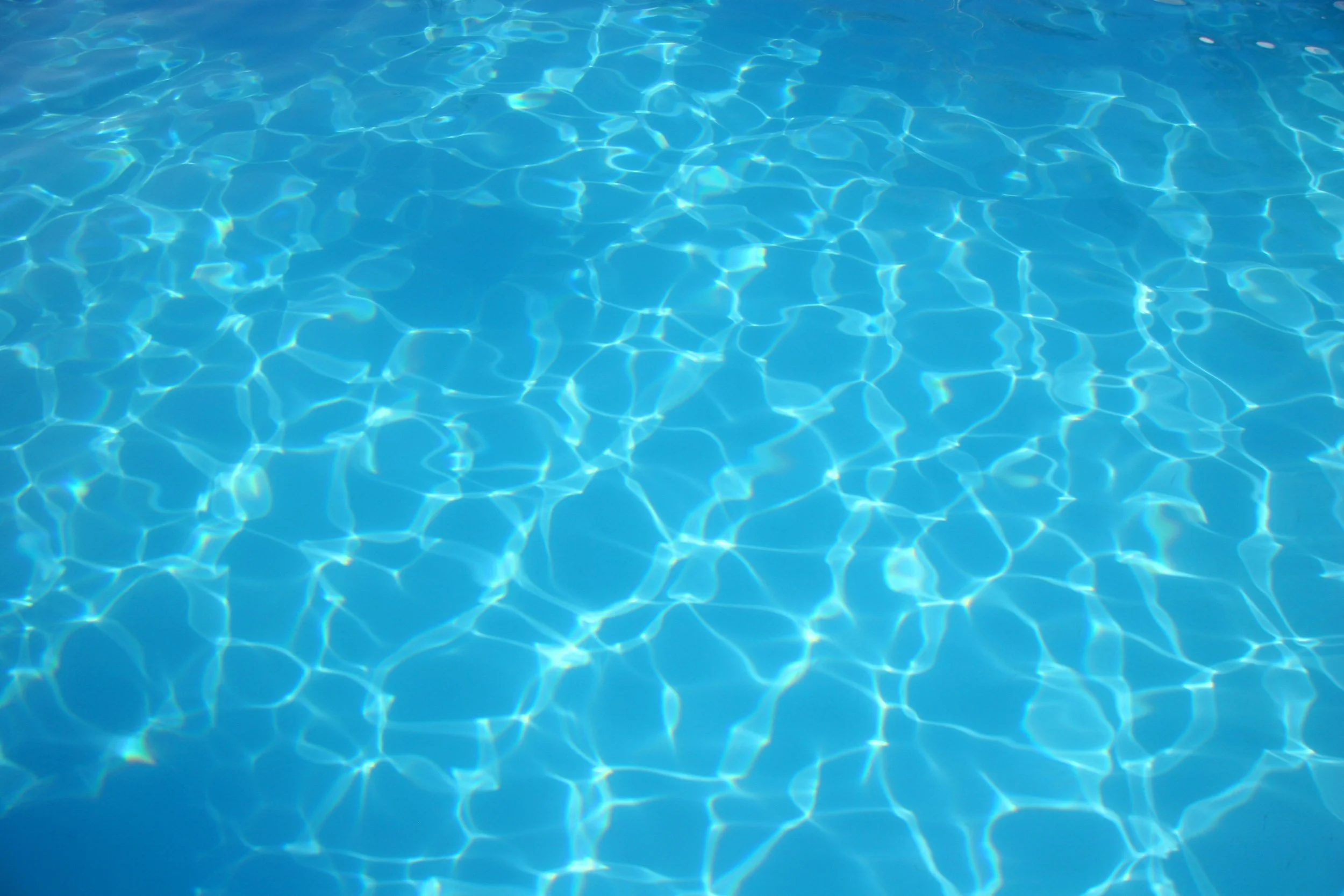 Rippling water texture in a blue gunite pool
