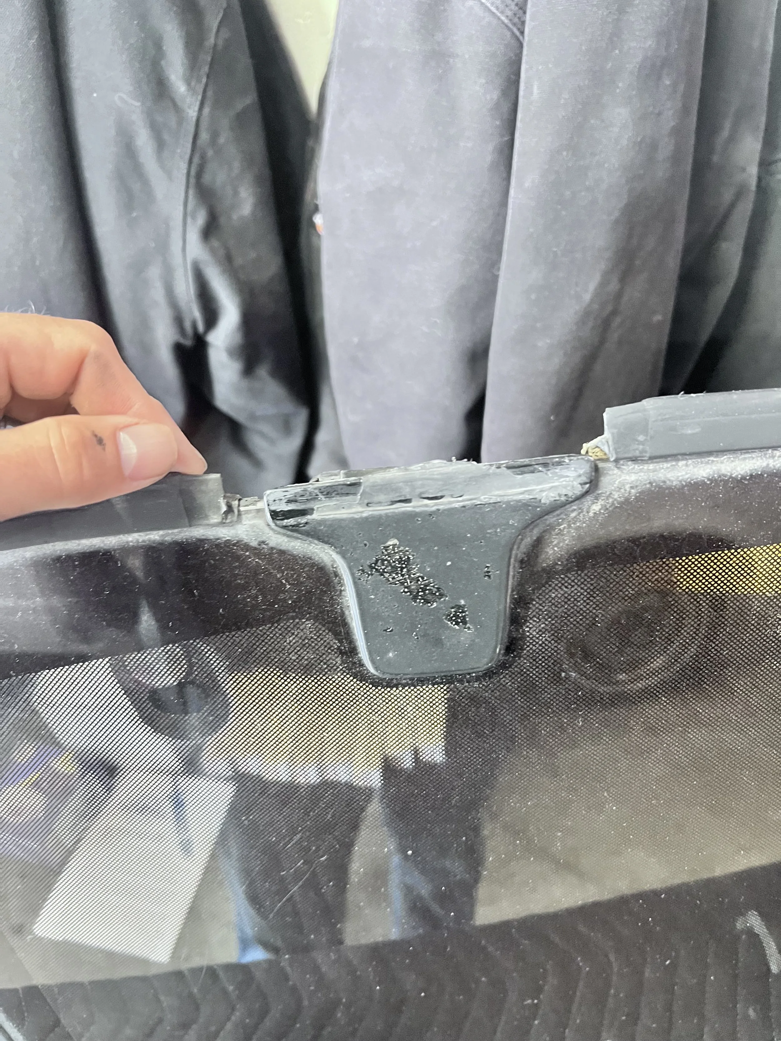 Access — Deteriorated trim and seal lifted to inspect the suspected vehicle water-leak path.
