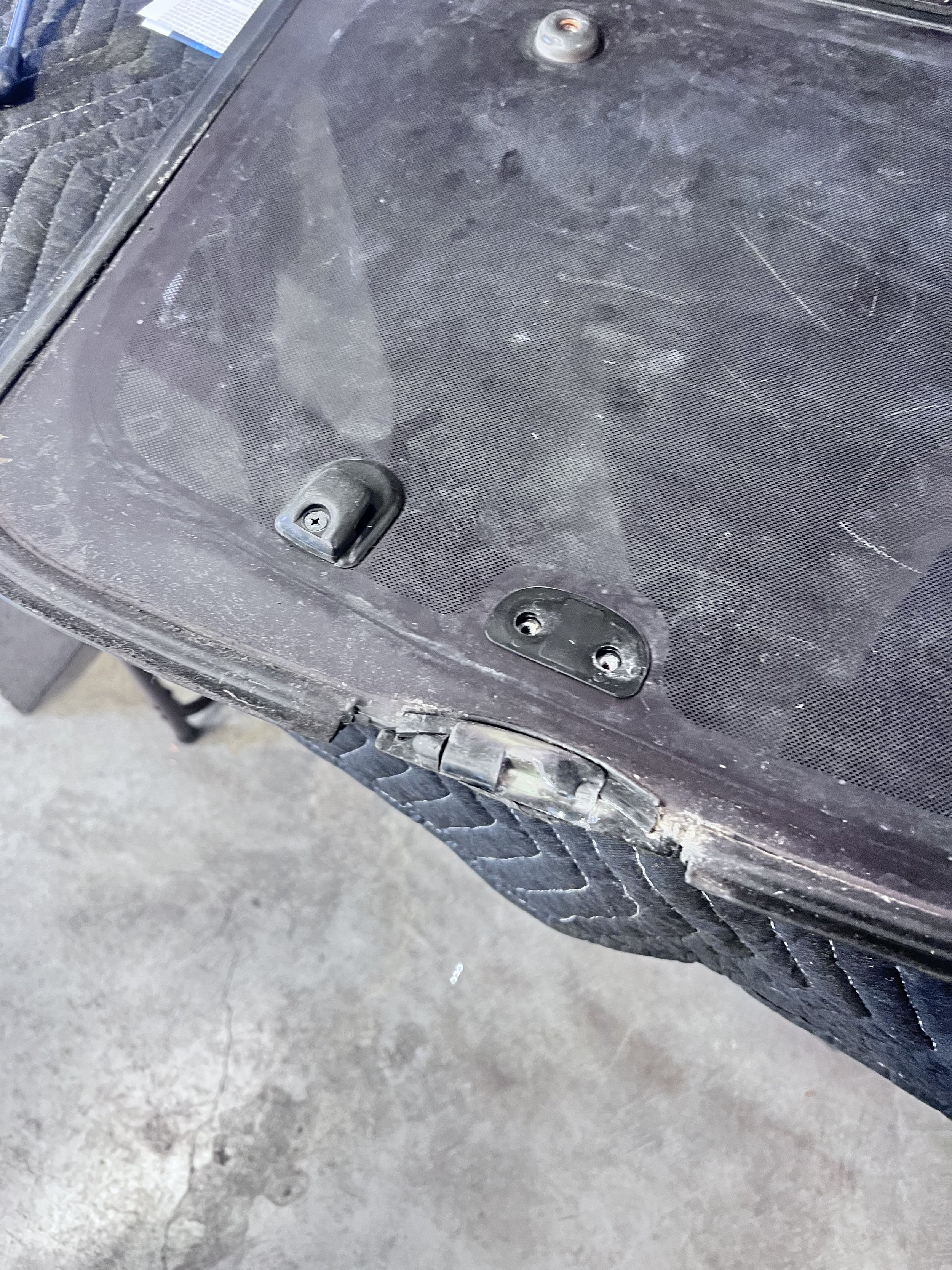 Inspection — Hidden underside of the sunroof glass and panel exposed to evaluate seal and bonding deterioration.