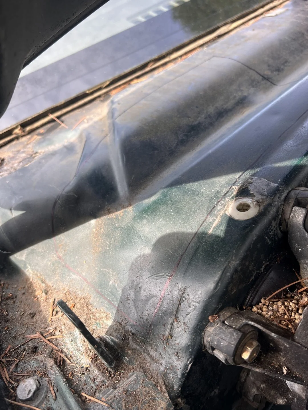Cowl-area water-leak diagnosis — Debris accumulation documented near the fresh-air and drainage area.