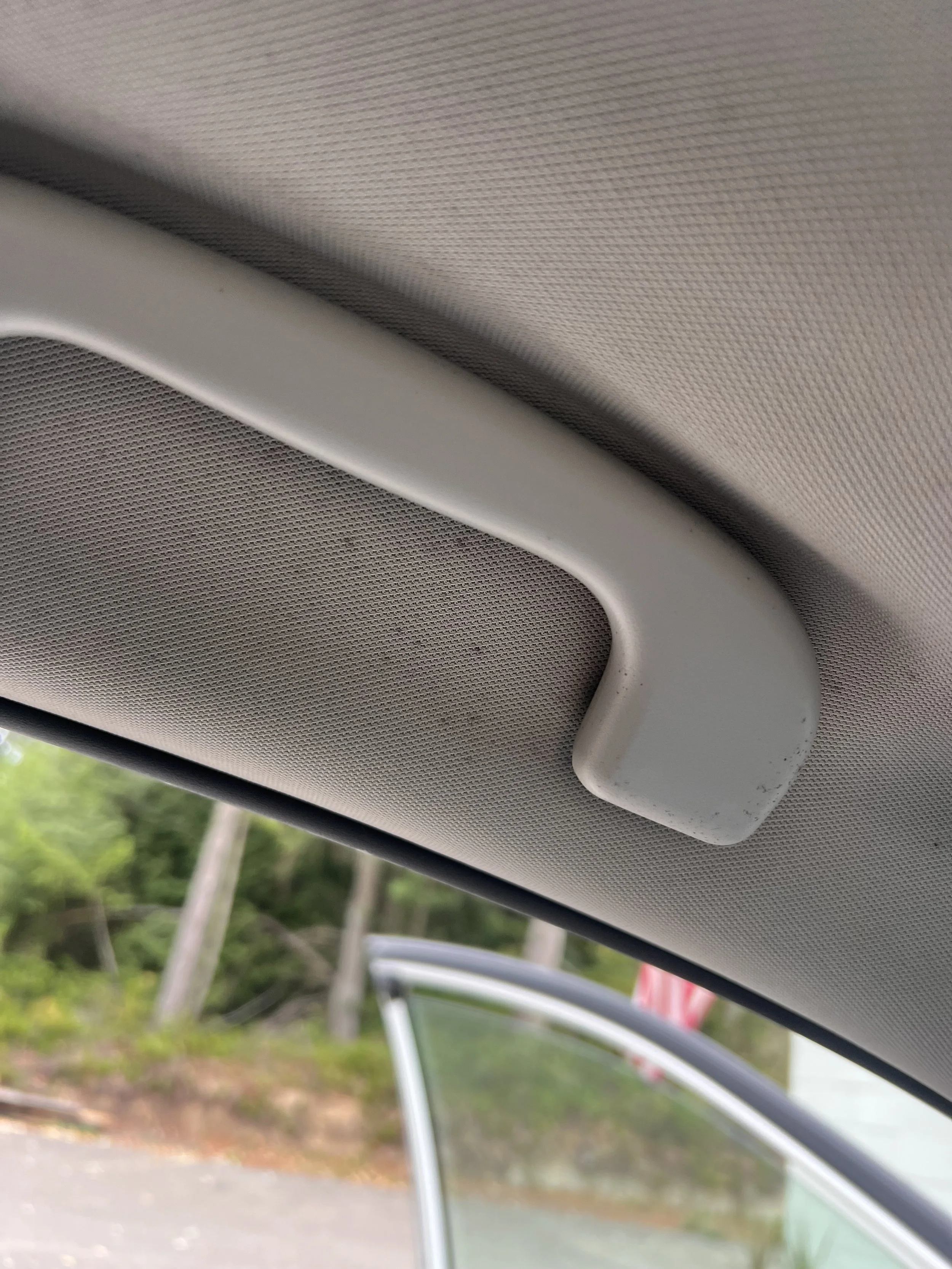 Evidence — Headliner discoloration documented near the sunroof opening.