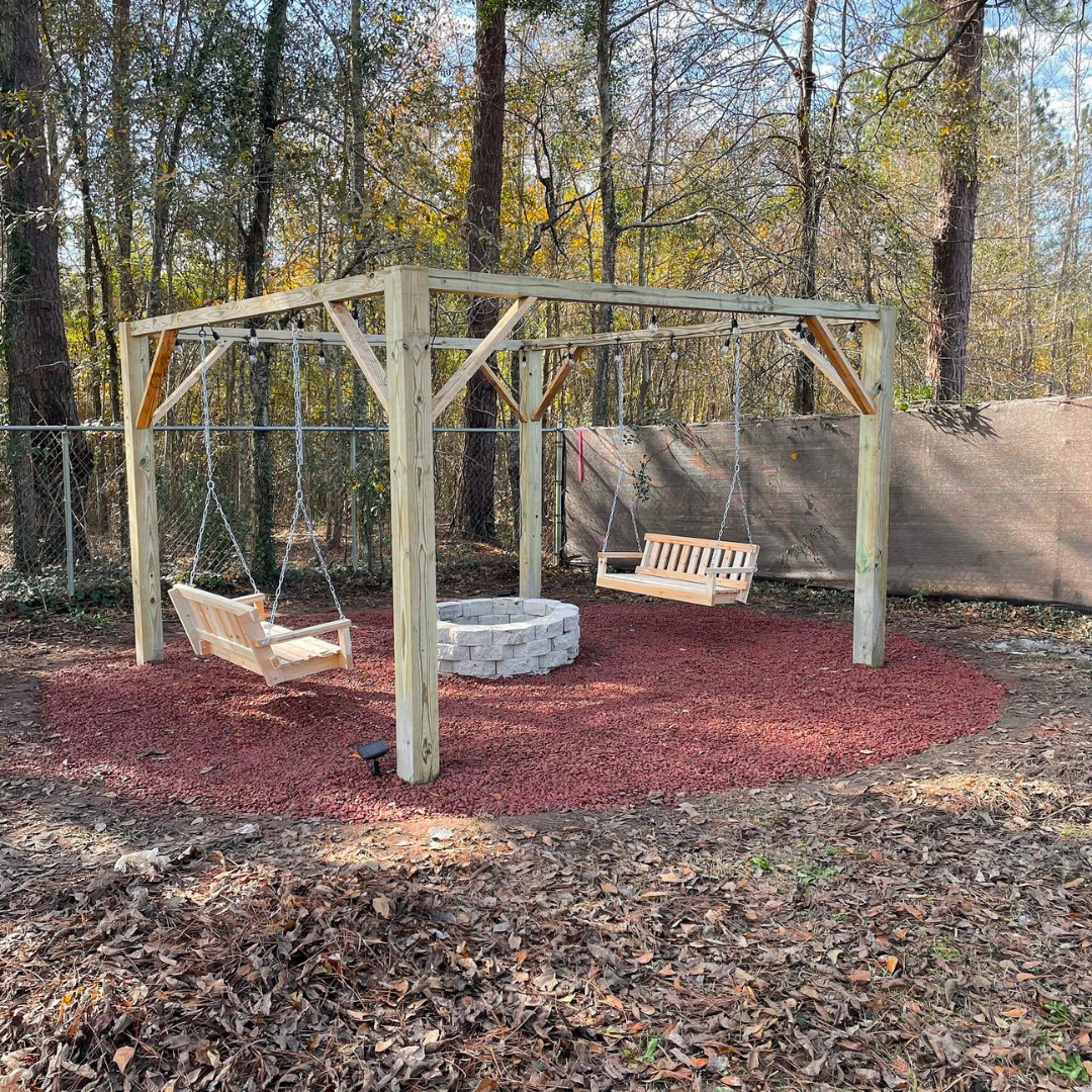 Backyard outdoor firepit area. outdoor firepit area with swings and hanging lights.