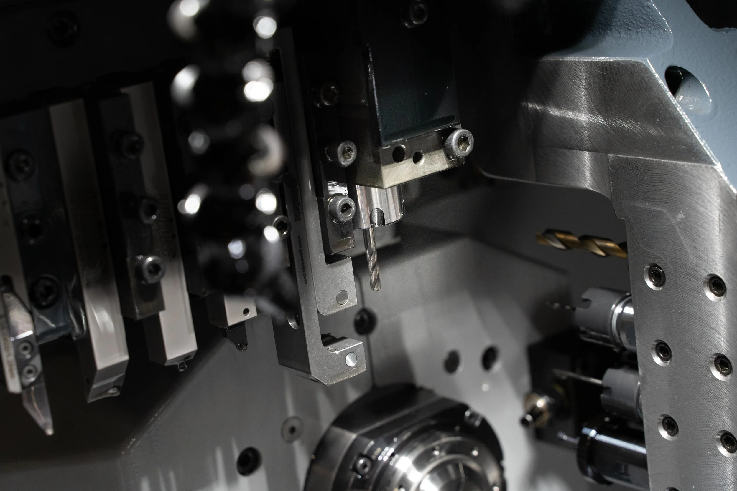 Close-up of a cross drilling or cross milling attachment inside of a Swiss lathe that can create complex components.