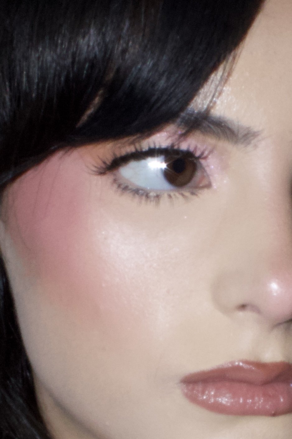 Close-up of a woman's face showing her eye, cheek, and part of her lips.