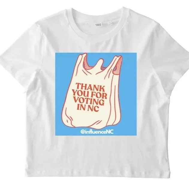 White T-shirt featuring an illustration of a hand making a gesture, with text that says 'Thank you for voting in NC' and '@influenceNC' at the bottom.