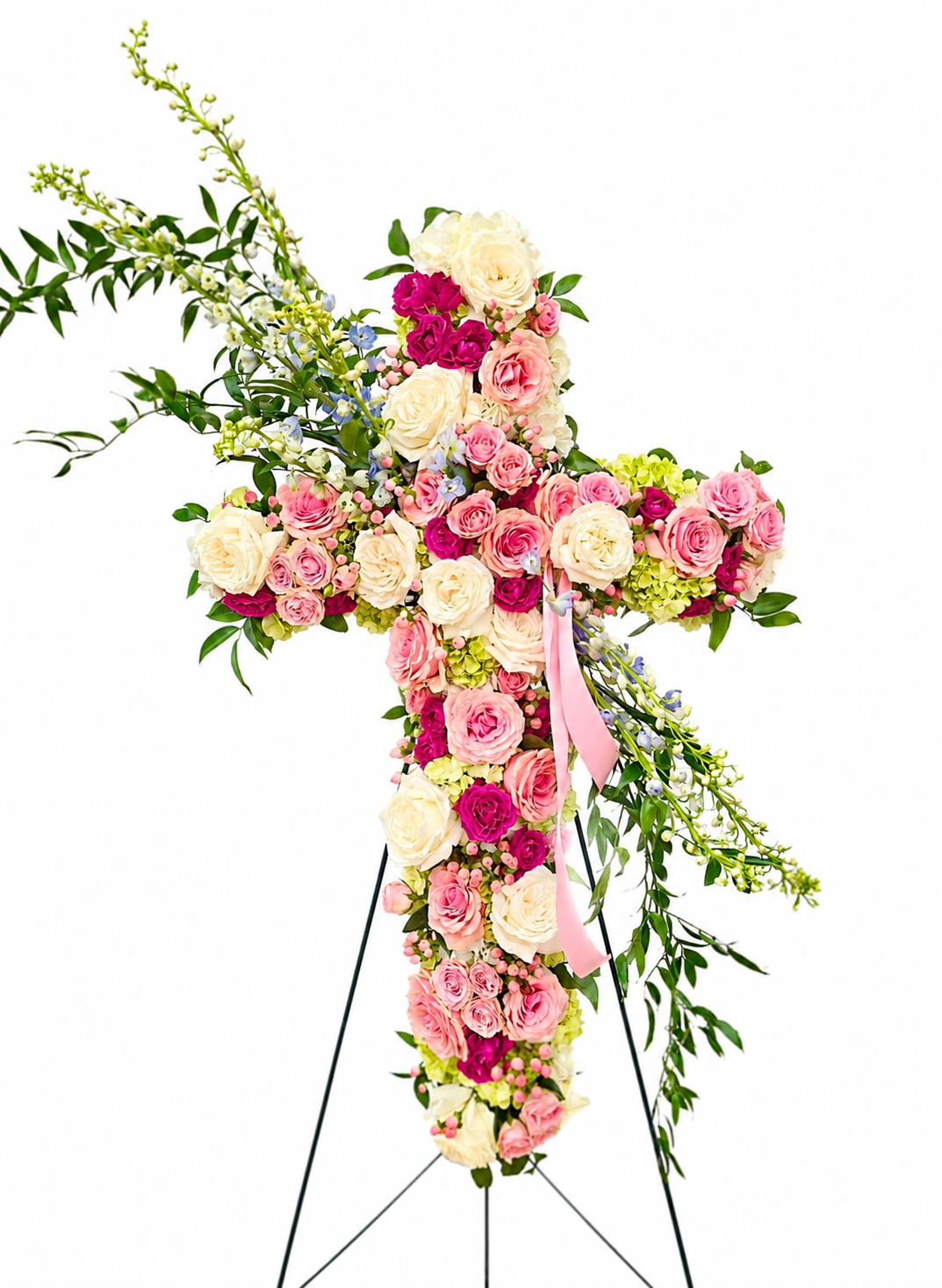 A soft and traditional cross in pinks, whites, and greens. We can customize pieces that truly honor your loved ones. 