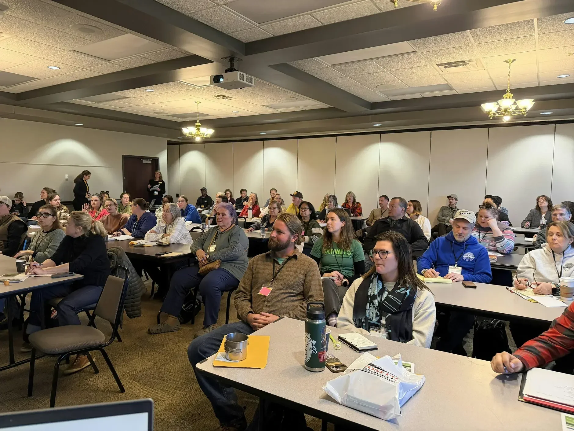 Image of conference attendees listening to a presenter.