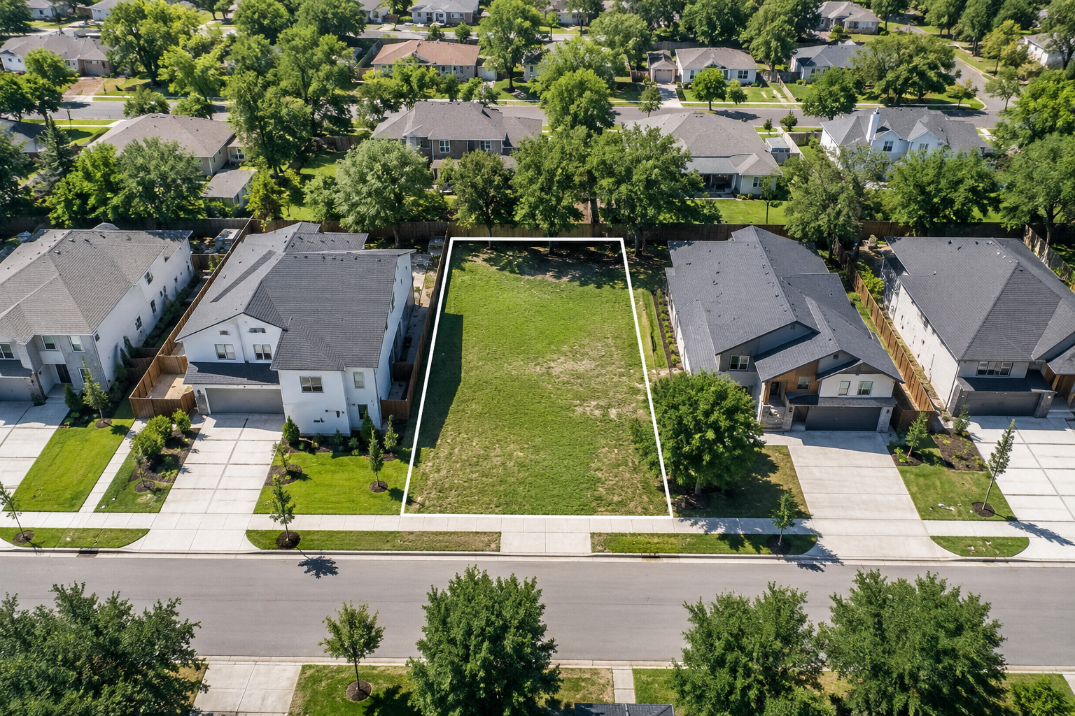 Infill vacant lot next to new residential homes.