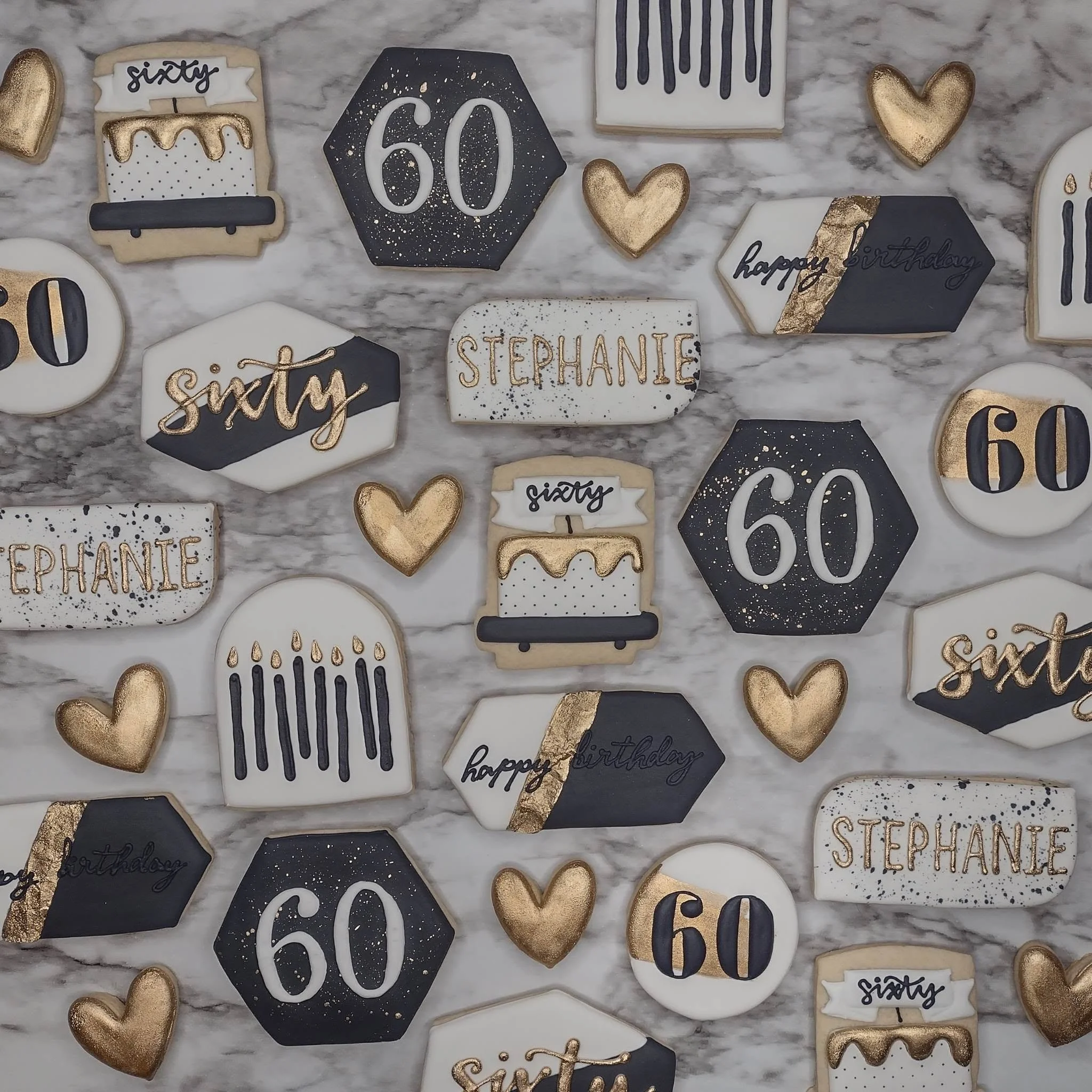 Decorative cookies with gold and black accents celebrating Stephanie's 60th birthday, including hearts, a number 60, and birthday messages.