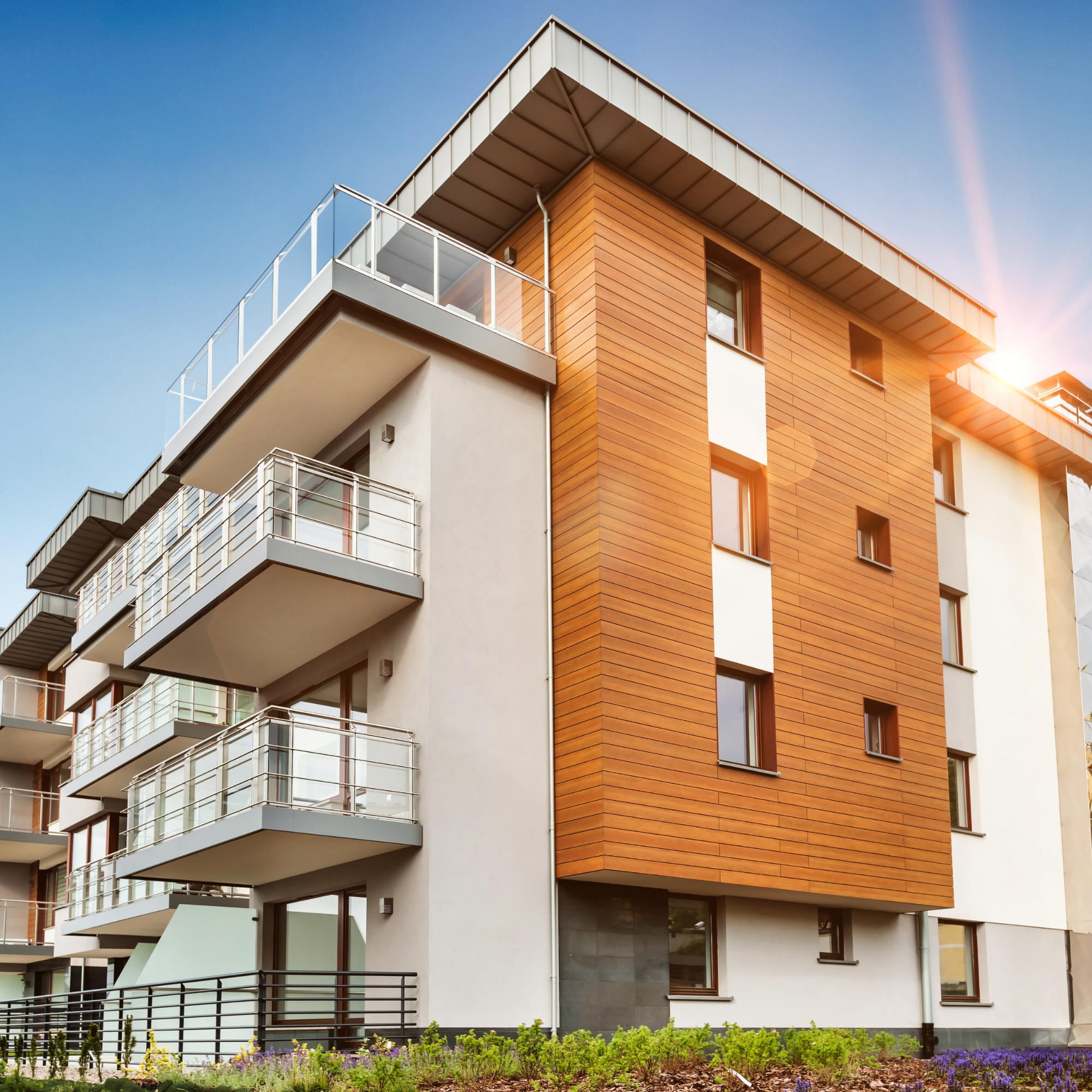 Modern multi-story apartment building with balconies and contemporary exterior design.