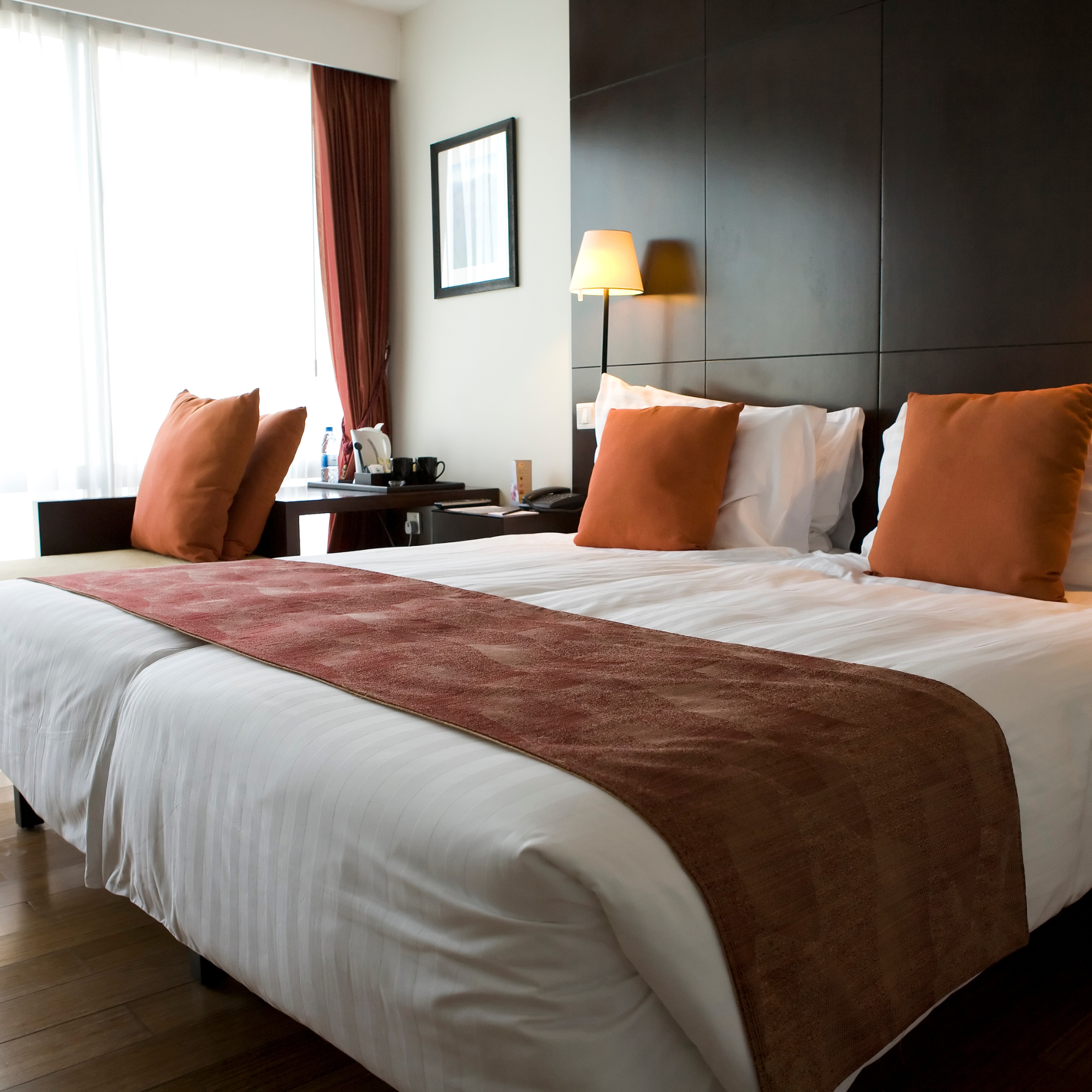 Clean and welcoming hotel guest room prepared by professional hospitality cleaning services.