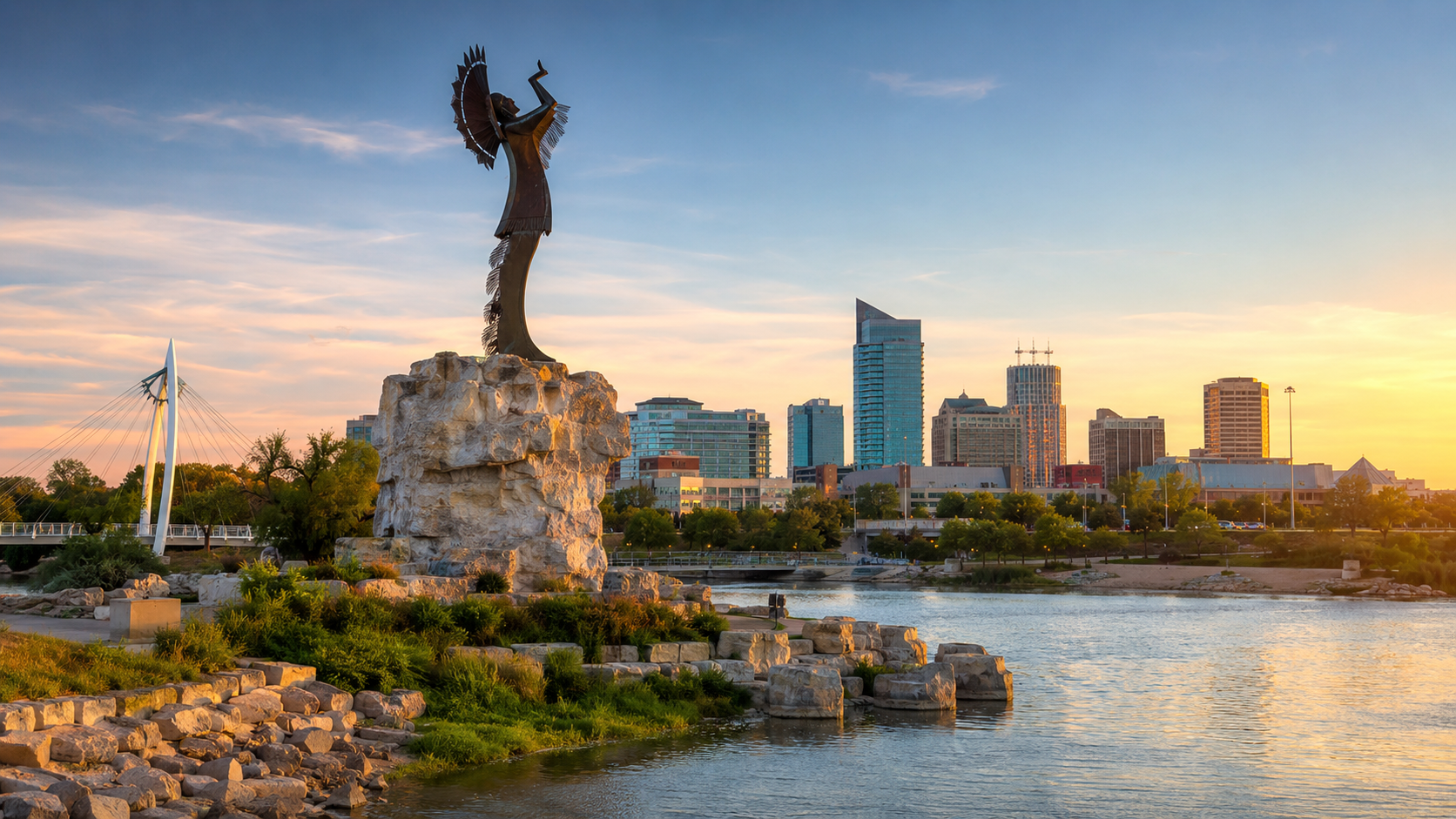 The Keeper of the Plains overlooking the river and downtown Wichita skyline at sunset.