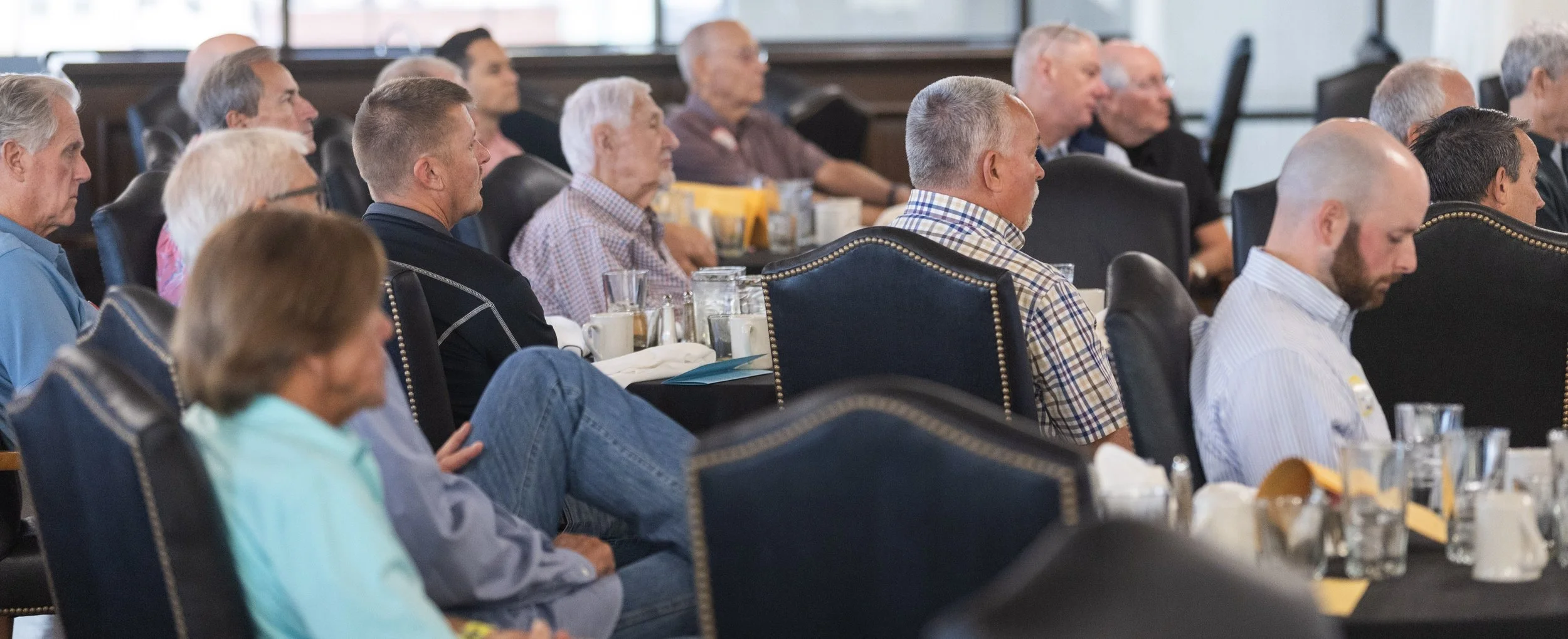 Wichita Executives’ Association members seated at tables during a breakfast meeting.